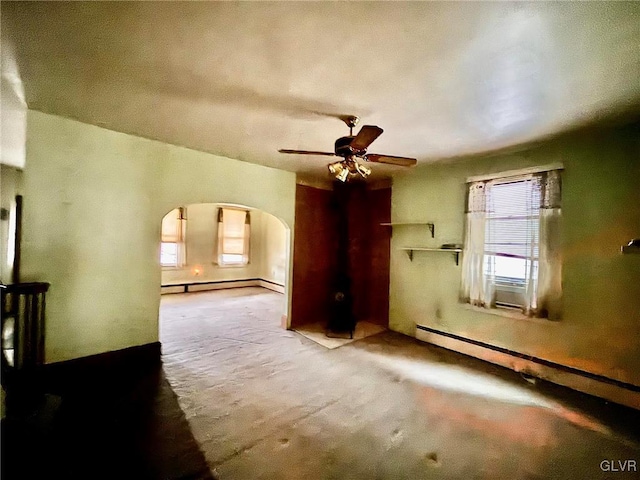 additional living space with a baseboard radiator, light carpet, and ceiling fan