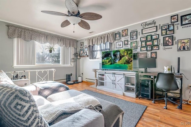 living room featuring wood-type flooring, ceiling fan, and baseboard heating