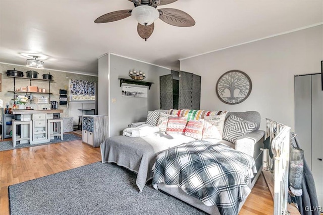 bedroom with hardwood / wood-style flooring and ornamental molding