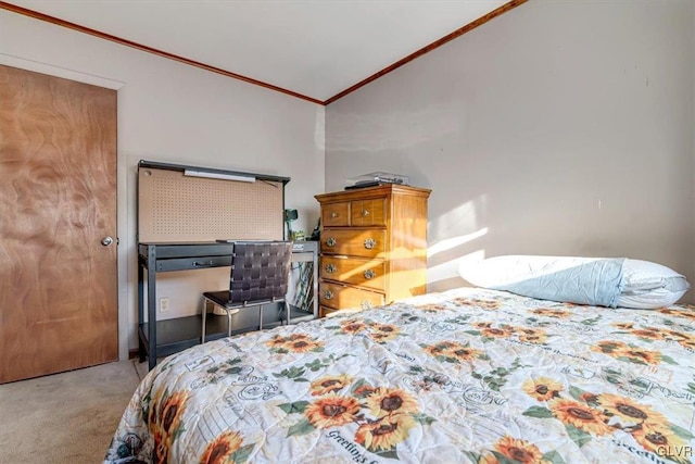 carpeted bedroom with crown molding and vaulted ceiling