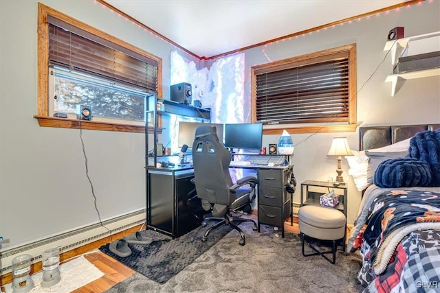 office area featuring crown molding, a baseboard heating unit, and light wood-type flooring