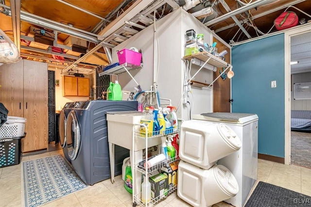 laundry room featuring cabinets and washer and clothes dryer