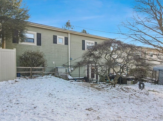 view of snow covered rear of property