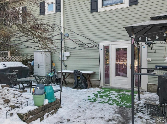 snow covered patio featuring area for grilling