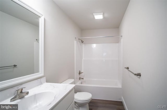 full bathroom with vanity, hardwood / wood-style floors,  shower combination, and toilet