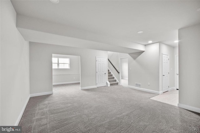 unfurnished room featuring light colored carpet