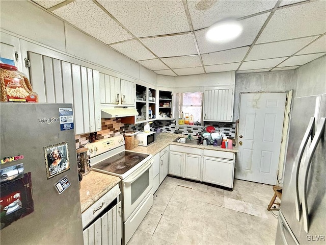 kitchen featuring a paneled ceiling, stainless steel refrigerator, white cabinets, and white electric range oven