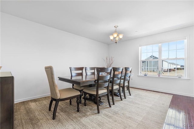 dining space featuring a notable chandelier and hardwood / wood-style floors