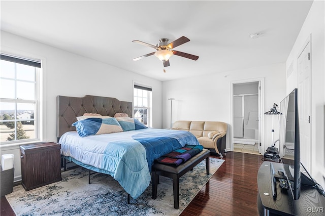 bedroom featuring dark wood-type flooring, ceiling fan, and ensuite bathroom