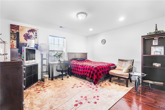 bedroom with hardwood / wood-style flooring