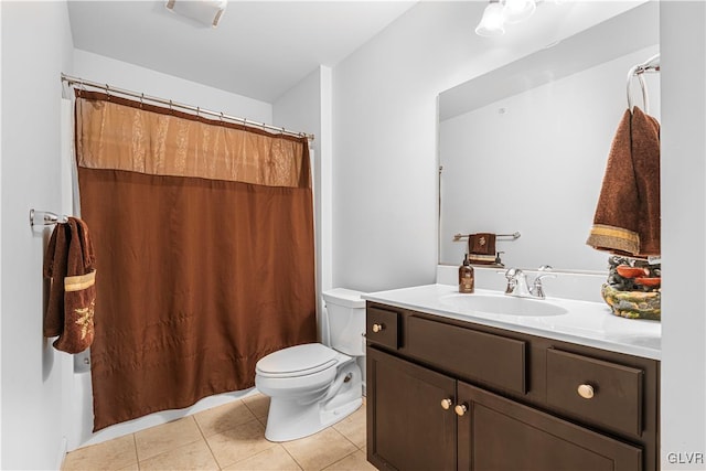 bathroom with vanity, toilet, and tile patterned flooring