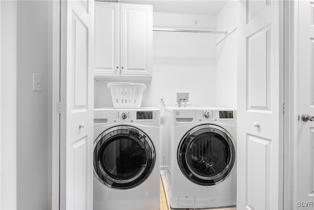 clothes washing area with independent washer and dryer and cabinets