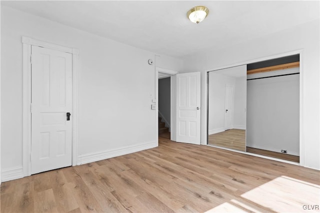 unfurnished bedroom featuring a closet and light hardwood / wood-style flooring