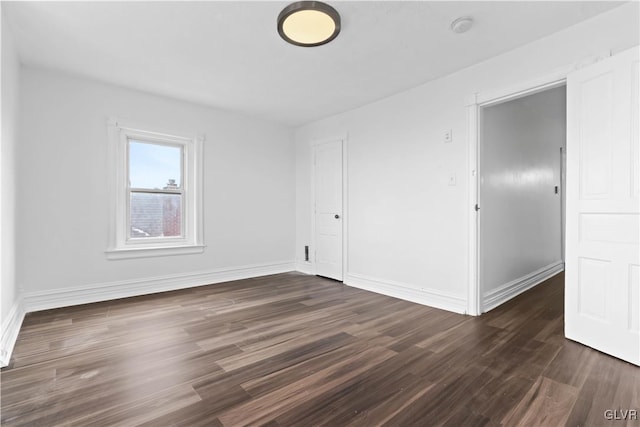 empty room featuring dark hardwood / wood-style flooring