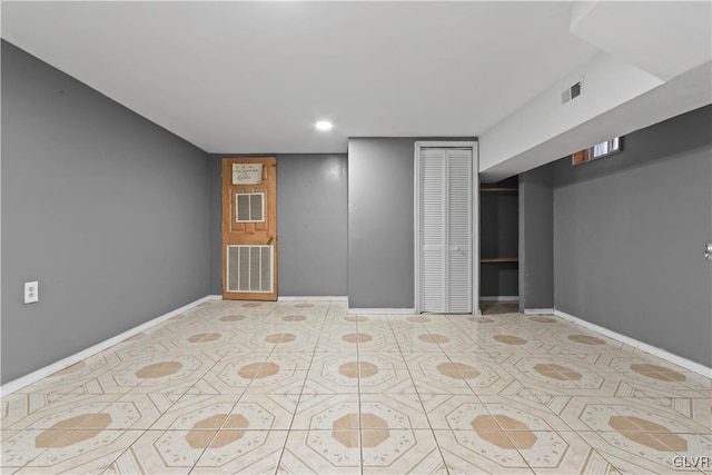 basement featuring light tile patterned floors