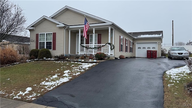 view of front of house featuring a porch, a garage, and a lawn