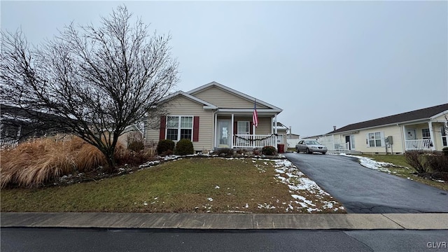 view of front of property with a porch and a front lawn