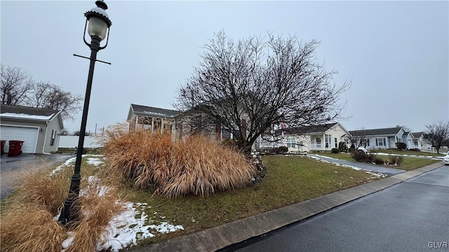 exterior space featuring a garage and a front yard