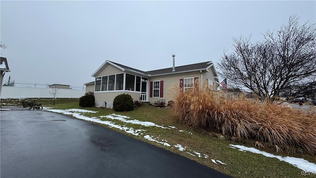 view of front of property featuring a sunroom