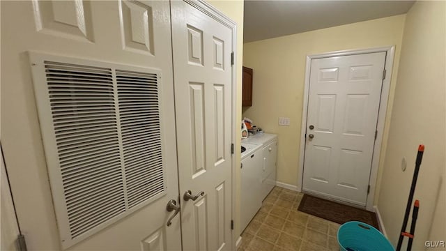 washroom with washing machine and dryer and cabinets