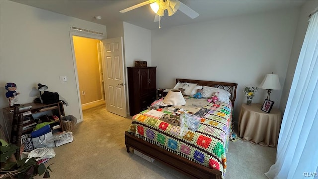 bedroom featuring light carpet and ceiling fan