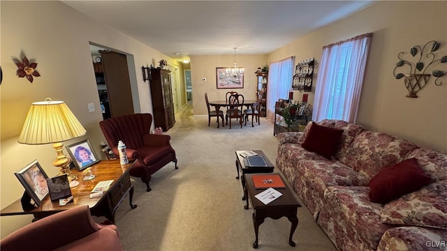 living room with light colored carpet and a chandelier