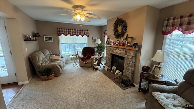 living room featuring ceiling fan, carpet flooring, and a fireplace