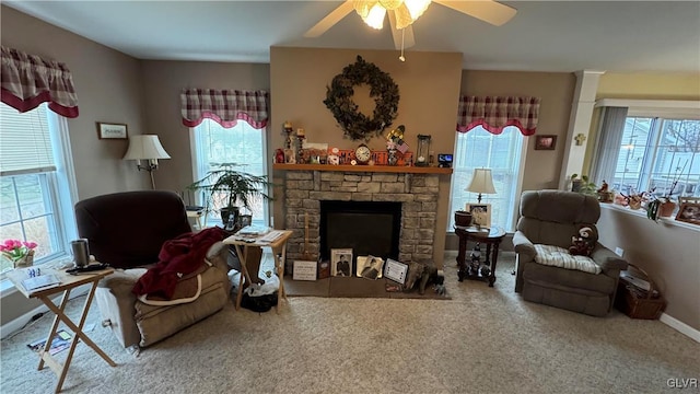 sitting room featuring ceiling fan, a fireplace, and carpet floors