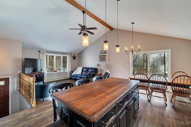 dining room with hardwood / wood-style flooring, a healthy amount of sunlight, and vaulted ceiling with beams