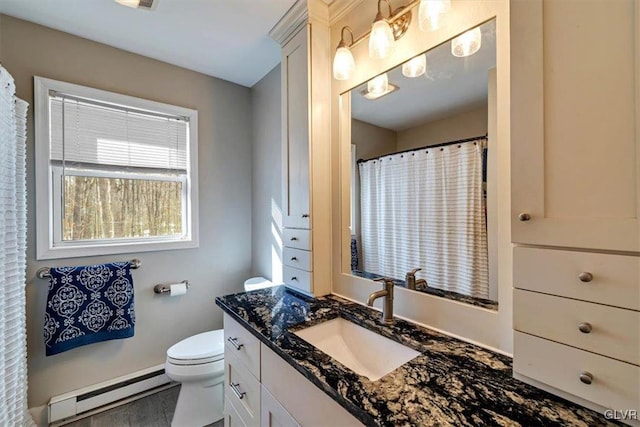 bathroom with a baseboard radiator, vanity, and toilet