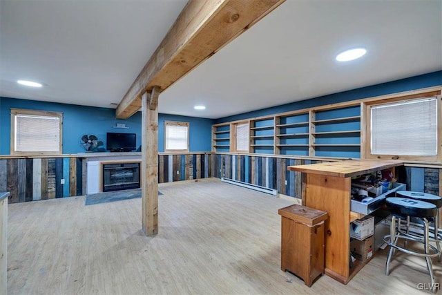 home office featuring beamed ceiling and light wood-type flooring