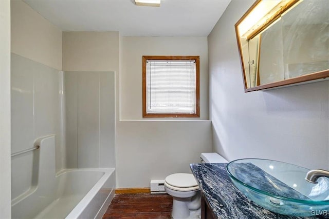 full bathroom featuring hardwood / wood-style flooring, baseboard heating, vanity, bathtub / shower combination, and toilet