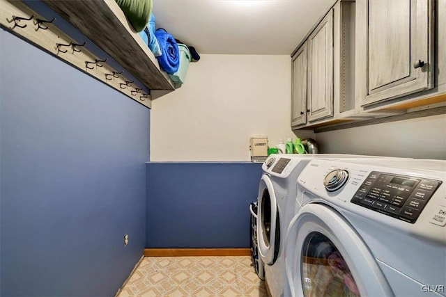 laundry area featuring cabinets and washer and clothes dryer