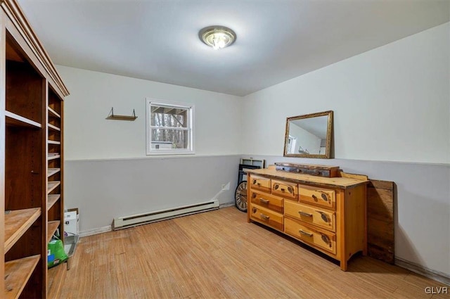 bedroom featuring baseboard heating and light hardwood / wood-style floors