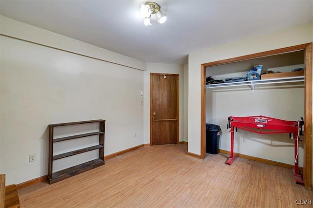 bedroom featuring hardwood / wood-style floors and a closet