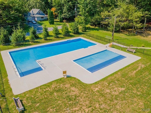 view of pool with a yard