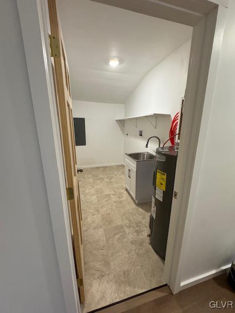 laundry room with water heater and sink