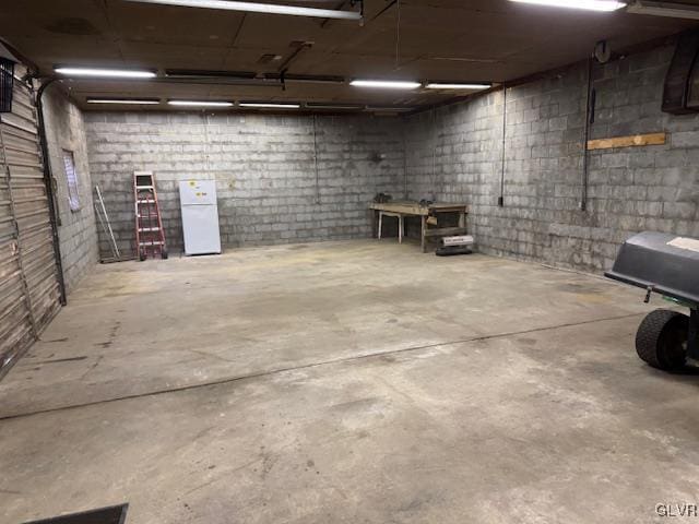 basement with white refrigerator