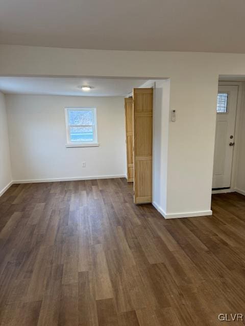 unfurnished room featuring dark hardwood / wood-style flooring