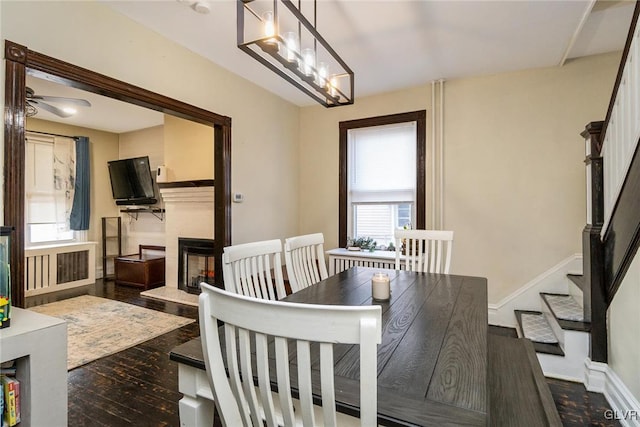 dining space with dark wood-type flooring