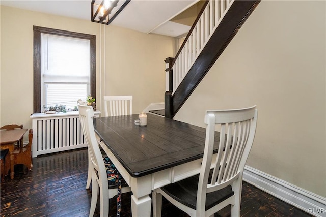 dining area with radiator and dark hardwood / wood-style floors