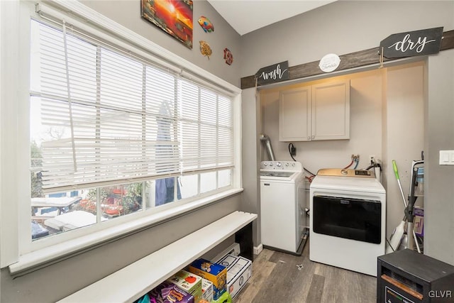 laundry room featuring cabinets, separate washer and dryer, and dark wood-type flooring