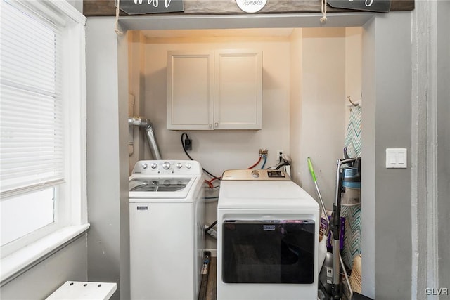 laundry room with cabinets and washer and clothes dryer