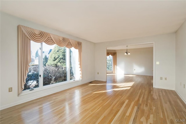 unfurnished room with light hardwood / wood-style floors