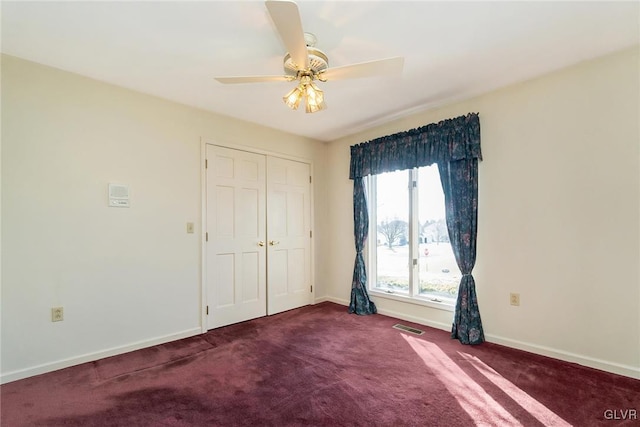 unfurnished bedroom with ceiling fan, carpet floors, and a closet