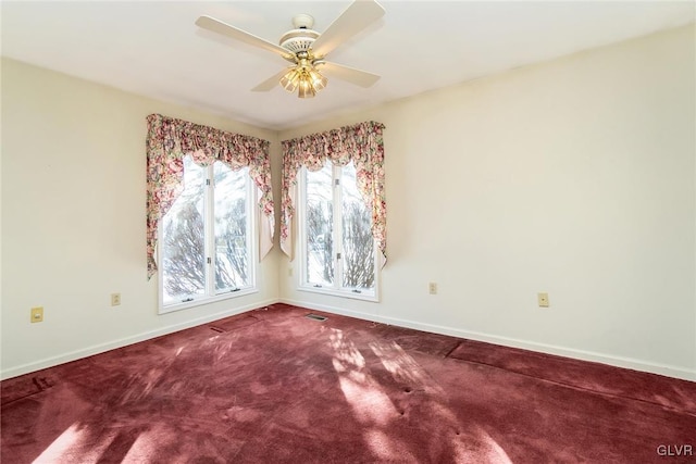 spare room featuring ceiling fan and carpet