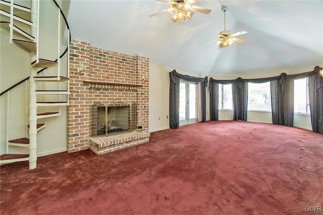 unfurnished living room featuring lofted ceiling, a brick fireplace, ceiling fan, and carpet flooring