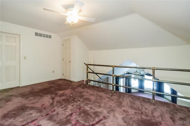 bonus room featuring vaulted ceiling and carpet