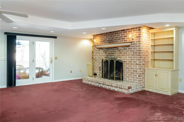 unfurnished living room featuring ceiling fan, carpet floors, and a fireplace