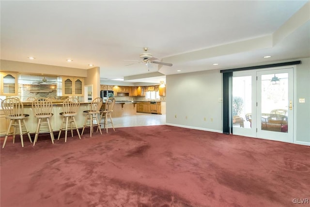 unfurnished living room with carpet floors and ceiling fan